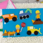 felt construction set spread out on felt play mat with envelope