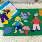 dressed felt dolls on play mat