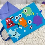 Monster felt pieces spread on travel mat