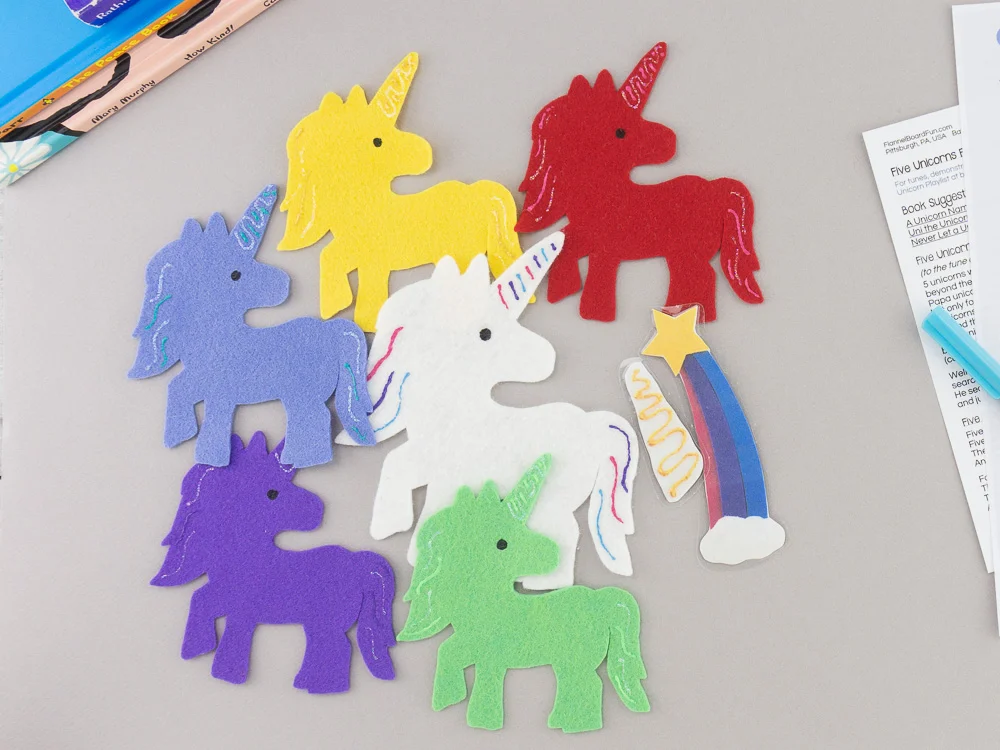 Five felt unicorns on desk